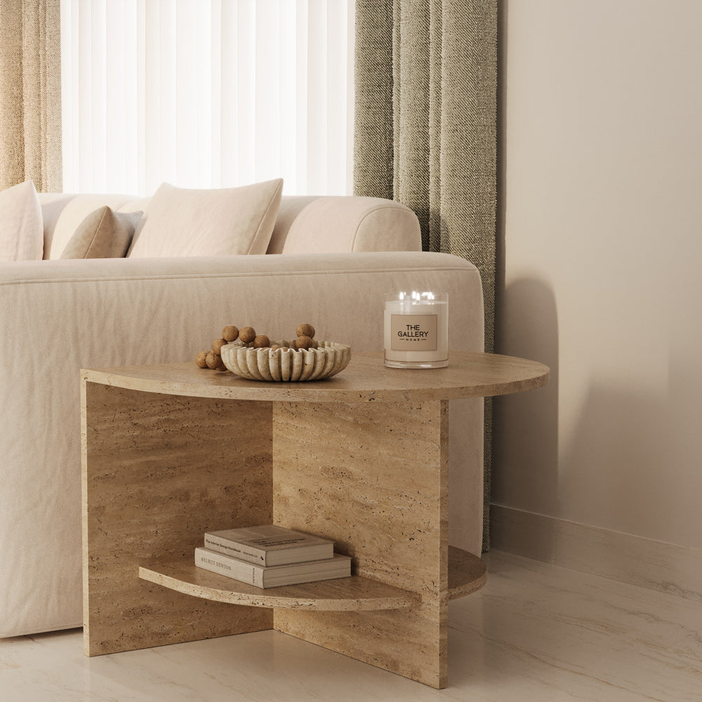 Travertine side table beside a linen sofa by The Gallery Home