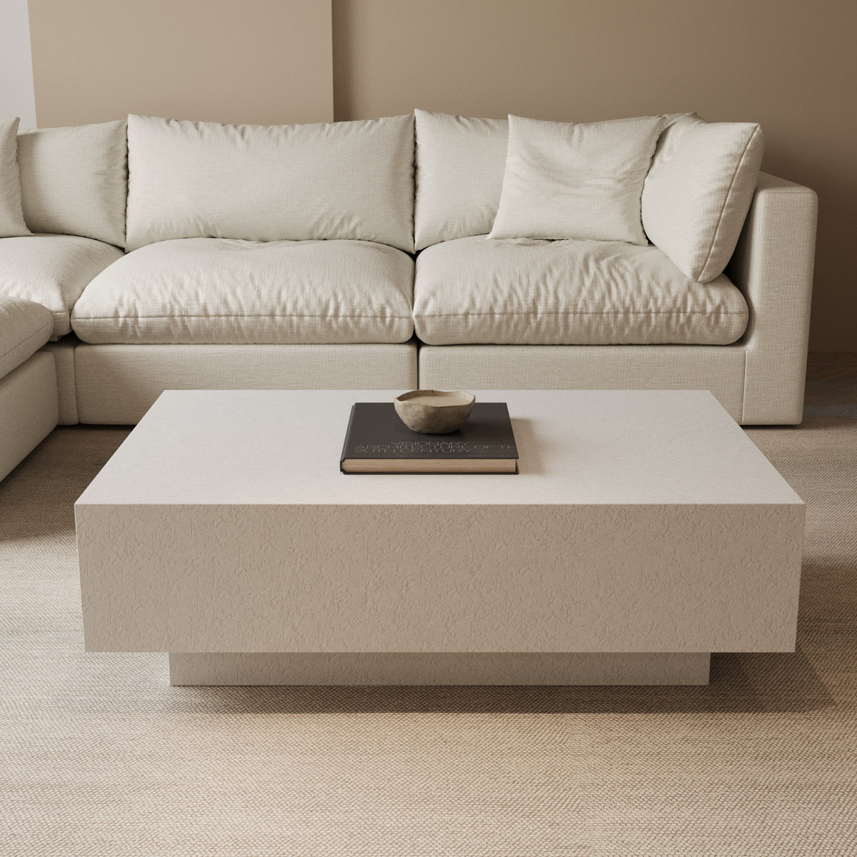 Textured floating cube coffee table in front of a modular sofa by The Gallery Home