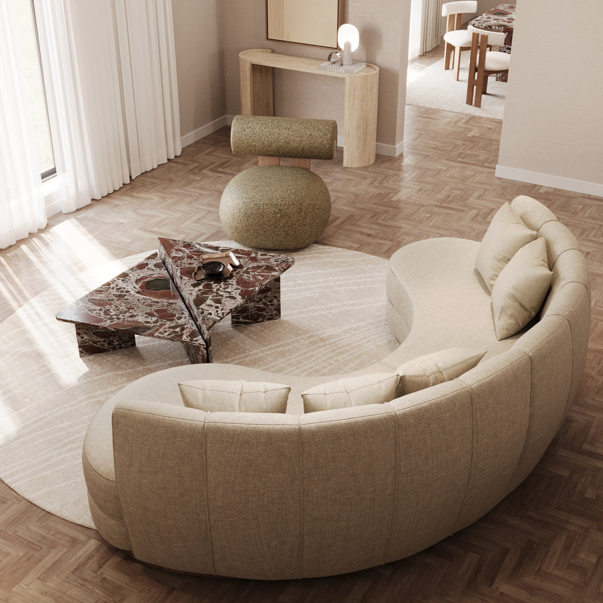 Living room with curved sofa and marble coffee table by The Gallery Home